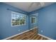 A bedroom with wood-look flooring featuring a mirrored closet and a window view at 1051 Forrest Nelson Blvd # 104, Port Charlotte, FL 33952