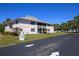 Exterior shot of condo building with screen doors, landscaping and two stories at 1051 Forrest Nelson Blvd # 104, Port Charlotte, FL 33952