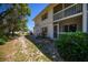 Exterior shot of condo building with screen doors, landscaping and two stories at 1051 Forrest Nelson Blvd # 104, Port Charlotte, FL 33952
