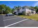 Exterior shot of condo building with parking, landscaping and two stories at 1051 Forrest Nelson Blvd # 104, Port Charlotte, FL 33952
