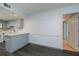 Open kitchen area with gray cabinetry, a breakfast bar, and stainless steel appliances at 1051 Forrest Nelson Blvd # 104, Port Charlotte, FL 33952