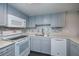 Updated kitchen boasts modern appliances, sleek countertops, stylish backsplash, and painted cabinets at 1051 Forrest Nelson Blvd # 104, Port Charlotte, FL 33952
