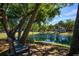 Community pond with bench seating surrounded by lush greenery and trees at 1051 Forrest Nelson Blvd # 104, Port Charlotte, FL 33952