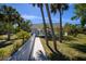 Community pool house with palm trees and lush landscaping surrounding at 1051 Forrest Nelson Blvd # 104, Port Charlotte, FL 33952