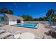 Community pool area featuring a sparkling pool, plenty of lounge chairs, and a nearby clubhouse at 1051 Forrest Nelson Blvd # 104, Port Charlotte, FL 33952