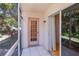 Charming screened porch with tile flooring and a door leading to the lush outdoor scenery at 1051 Forrest Nelson Blvd # 104, Port Charlotte, FL 33952