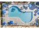 Aerial shot of a resort-style pool with lounge chairs and umbrellas at 1085 Jonah Dr, North Port, FL 34289