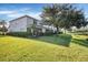 Lush backyard with green lawn leading to a tranquil pond setting at 1085 Jonah Dr, North Port, FL 34289