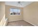 Bedroom with neutral carpet, window, and a ceiling fan at 1085 Jonah Dr, North Port, FL 34289
