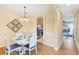 Inviting dining room featuring an arched doorway to the kitchen and views into living area at 1085 Jonah Dr, North Port, FL 34289