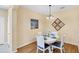 The dining room has hardwood flooring, a round table, and seating for four at 1085 Jonah Dr, North Port, FL 34289