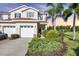 Charming two-story home boasts a red door, manicured landscaping, and a one-car garage at 1085 Jonah Dr, North Port, FL 34289