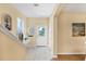 Welcoming foyer with tile flooring, a staircase, and a white front door with a window at 1085 Jonah Dr, North Port, FL 34289