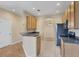 Efficient kitchen with breakfast bar, wood cabinetry, and stainless steel appliances at 1085 Jonah Dr, North Port, FL 34289