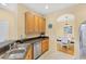 The kitchen has wooden cabinets, granite counters, and stainless steel appliances with an open concept at 1085 Jonah Dr, North Port, FL 34289