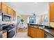 Open kitchen featuring granite counters, stainless appliances, and a breakfast bar overlooking the living area at 1085 Jonah Dr, North Port, FL 34289
