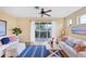 Bright living room features wood floors, neutral walls, ceiling fan, and backyard view at 1085 Jonah Dr, North Port, FL 34289