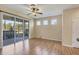 Bright living room with wood floors, ceiling fan, sliding glass doors to the lanai, and natural light at 1085 Jonah Dr, North Port, FL 34289