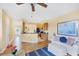 Bright living room adjacent to the kitchen features wood floors and neutral walls at 1085 Jonah Dr, North Port, FL 34289