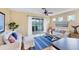 Bright living room features wood floors, neutral walls, ceiling fan, and view to the backyard at 1085 Jonah Dr, North Port, FL 34289