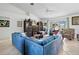 Spacious living room with tile floors, large sectional sofa, and entertainment center at 1140 Capricorn Blvd, Punta Gorda, FL 33983