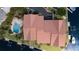 Breathtaking aerial view of a red roof house featuring a private pool, a parking area and surrounding waterways at 1326 Wesley Dr # 123, Punta Gorda, FL 33950