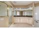 Elegant bathroom featuring a large vanity, granite countertop, and a glass enclosed shower at 1326 Wesley Dr # 123, Punta Gorda, FL 33950