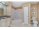 Well-lit bathroom featuring vanity, soaking tub, toilet, and adjacent linen closet at 1326 Wesley Dr # 123, Punta Gorda, FL 33950