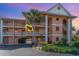 Inviting condo exterior featuring well-maintained landscaping and a glimpse of the private balcony at 1326 Wesley Dr # 123, Punta Gorda, FL 33950