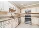 Bright kitchen featuring stainless steel appliances, granite counters, tile backsplash, and ample storage at 1326 Wesley Dr # 123, Punta Gorda, FL 33950