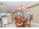 Inviting living room area with chandelier and slider to balcony showcasing water views at 1326 Wesley Dr # 123, Punta Gorda, FL 33950