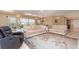 Spacious living room featuring comfortable seating, an elegant chandelier, and large windows at 1326 Wesley Dr # 123, Punta Gorda, FL 33950