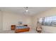 Relaxing bedroom featuring a ceiling fan, natural light, and comfortable seating area at 1326 Wesley Dr # 123, Punta Gorda, FL 33950