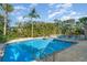 Sparkling in-ground pool with a patio, lush landscaping, and comfortable seating, perfect for relaxation and entertainment at 1326 Wesley Dr # 123, Punta Gorda, FL 33950