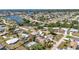 Aerial view of a waterfront neighborhood featuring lush greenery, canals, and various single-Gathering homes at 1357 Le Pera Rd, Englewood, FL 34223