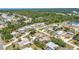 Suburban neighborhood aerial view with a mix of houses, green spaces, and tree-lined streets in a tranquil setting at 1357 Le Pera Rd, Englewood, FL 34223