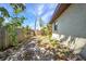 Fenced-in backyard with sandy ground, small plants, and partial shade at 1357 Le Pera Rd, Englewood, FL 34223