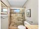 Bathroom featuring a glass shower, mosaic tile accents, and neutral color palette at 1357 Le Pera Rd, Englewood, FL 34223