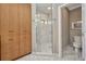 Bright bathroom featuring a glass enclosed shower and custom cabinet at 1357 Le Pera Rd, Englewood, FL 34223