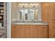 Bright bathroom featuring a double vanity, custom cabinets, and tile floors at 1357 Le Pera Rd, Englewood, FL 34223