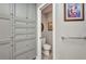 Bathroom showing a toilet and custom gray cabinets with pull out drawers at 1357 Le Pera Rd, Englewood, FL 34223