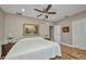 Bedroom with hardwood floors, neutral paint, ceiling fan, and bright windows at 1357 Le Pera Rd, Englewood, FL 34223