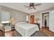 Charming bedroom with a ceiling fan, wood floors and plenty of natural light at 1357 Le Pera Rd, Englewood, FL 34223