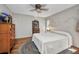 Bedroom features wood floors, a ceiling fan, and vintage furniture at 1357 Le Pera Rd, Englewood, FL 34223