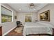 Bedroom with hardwood floors, neutral paint, and bright windows at 1357 Le Pera Rd, Englewood, FL 34223