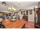 Open-concept living space with dining area and kitchen featuring pendant lighting at 1357 Le Pera Rd, Englewood, FL 34223