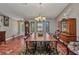 Dining room featuring a large table, vintage accents, and stained glass windows at 1357 Le Pera Rd, Englewood, FL 34223