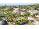 Charming single-story home features a well-manicured lawn with tropical plants and an inviting entrance at 1357 Le Pera Rd, Englewood, FL 34223