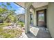 Inviting front entrance with a decorative glass door and well-maintained landscaping at 1357 Le Pera Rd, Englewood, FL 34223