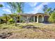 Charming single-story home featuring a well-manicured lawn and lush landscaping at 1357 Le Pera Rd, Englewood, FL 34223